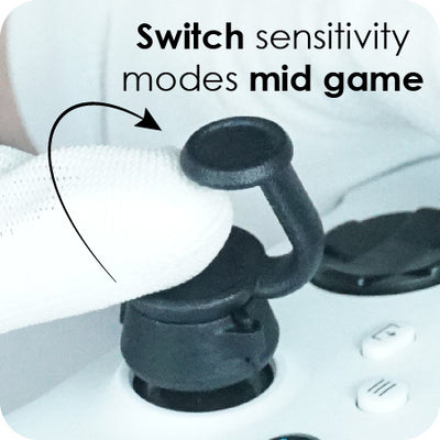 Close-up of a gaming controller with a feature labelled 'switch sensitivity modes mid game' on a blurred background.